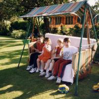 Sara Bayliss children with their cousins on the orginal family swing seat one Summer afternoon (1997)